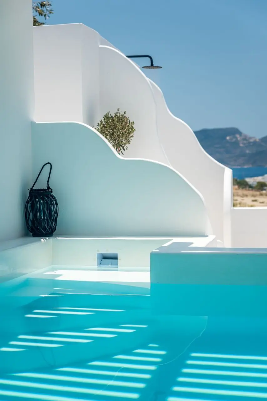 Sculpted white curves beside the pool