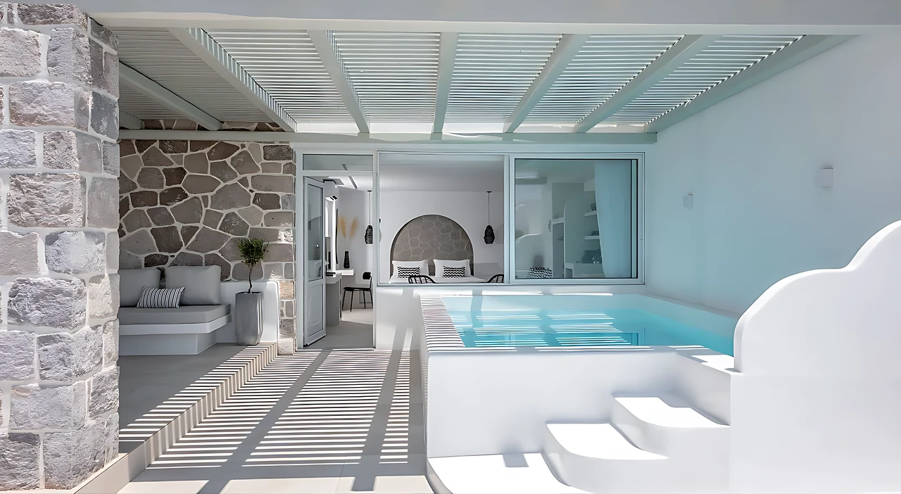 The terrace: stone, pergola shade and the room beyond